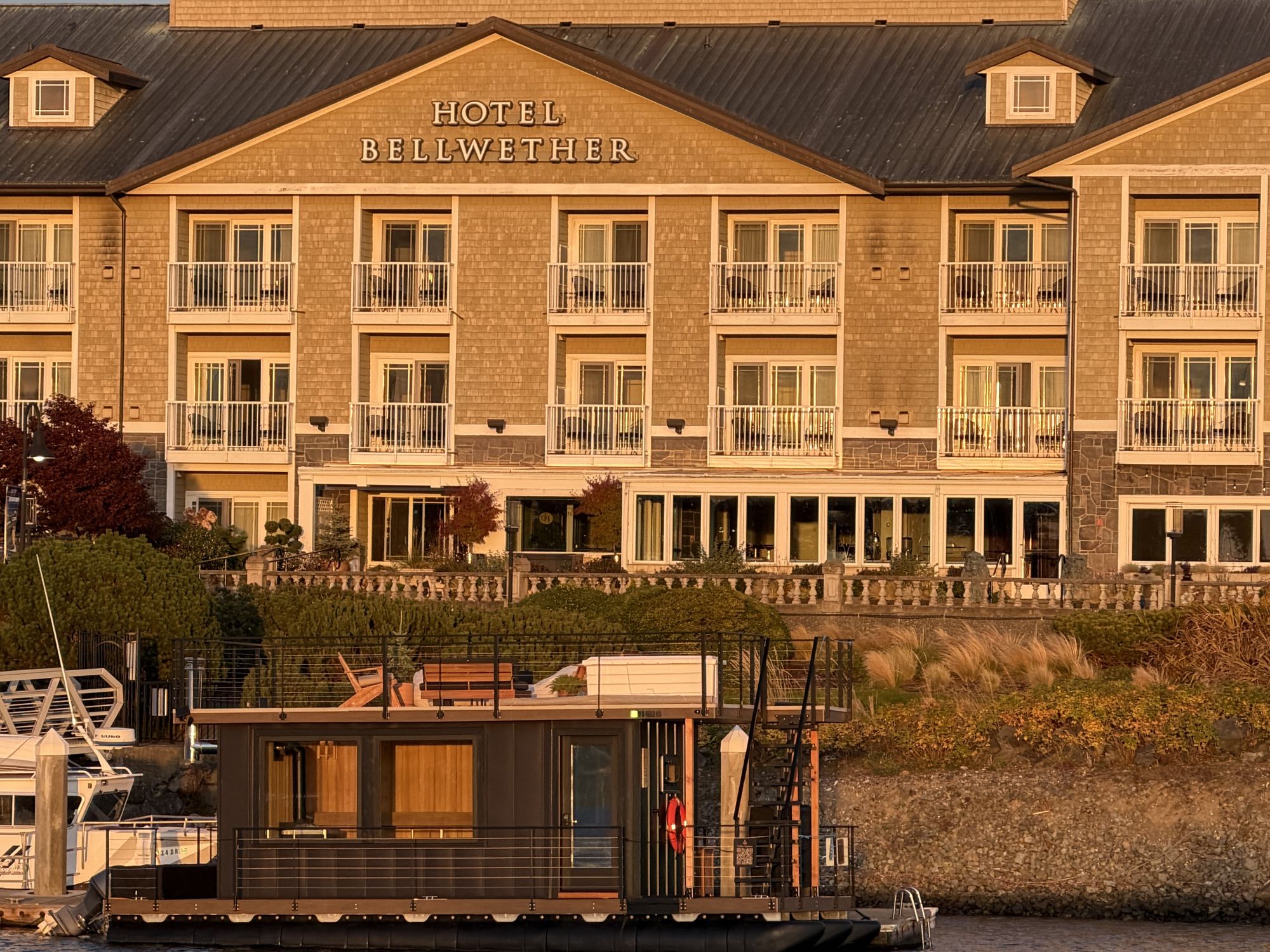 Hotel Bellwether at golden hour with the Drift floating sauna docked on the water below