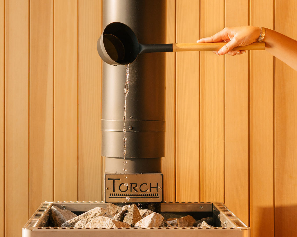 Water poured from a wooden ladle over the hot sauna stones