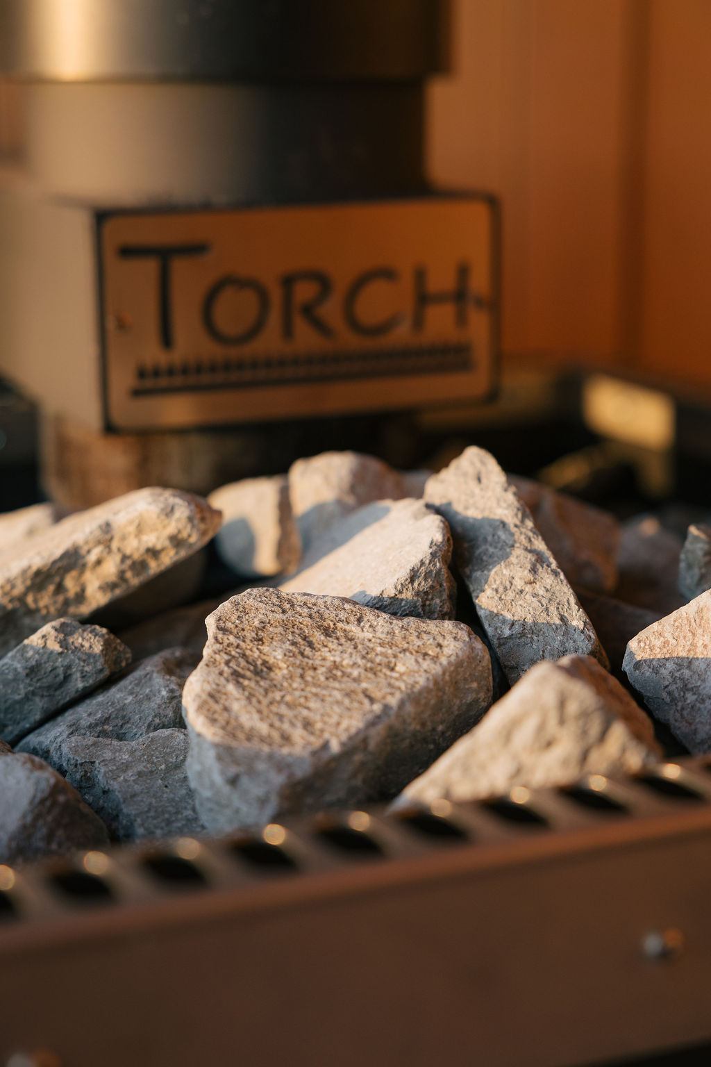 Close-up of the sauna stones heaped in the Torch stove